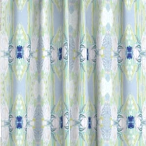 May include: A shower curtain with a light blue background and a white, green, and blue geometric pattern.