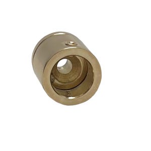 May include: Gold-toned metal end cap with a round opening. The end cap is designed to fit over a cord or cable.