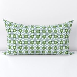 May include: A light blue and green patterned throw pillow with a geometric design.