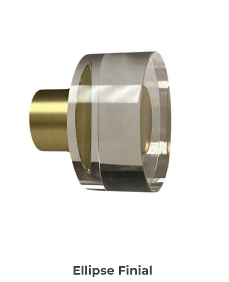 Pu&ograve; includere: Terminale ovale trasparente con base cilindrica color oro. Il terminale &egrave; realizzato in materiale trasparente. Il testo "Ellipse Finial" &egrave; in basso nell'immagine. Probabilmente per un bastone per tende.