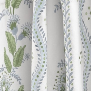 May include: White fabric with a repeating pattern of blue and green floral designs. The pattern features stylized leaves, flowers, and dots.