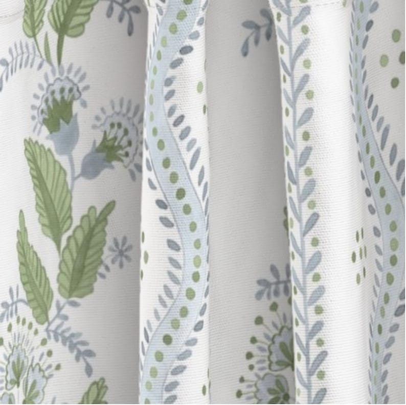 May include: White fabric with a repeating pattern of blue and green floral designs. The pattern features stylized leaves, flowers, and dots.