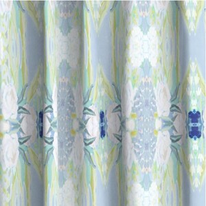 May include: A blue and white patterned fabric with a floral design. The fabric has a soft, flowing texture and is perfect for curtains, upholstery, or other home decor projects.