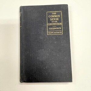 May include: A vintage hardcover book titled "The Common Sense of the Constitution" by Southworth, published by Allyn and Bacon. The book has a dark cover with gold lettering and a rectangular design.