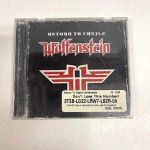 May include: A Return to Castle Wolfenstein PC game jewel case with a black cover featuring the red and white logo. A white sticker on the front displays the text: Return To Castle Wolfenstein, ID: 10140, Don't Lose This Number!, 3TSB-LG22-LRW7-LS2R-0A.
