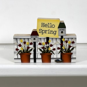 May include: Wooden spring-themed decoration with three potted tulips, two birdhouses, and a sign that reads "Hello Spring".