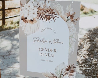 May include: A gender reveal sign with a beige background and brown and white floral accents. The sign reads "Welcome to Penelope & Nolan's Gender Reveal May 13, 20XX".