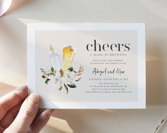 May include: A baby shower invitation with a light pink background and a floral design. The invitation says "Cheers, A Baby is Brewing" and includes the names "Abigail and Mike".