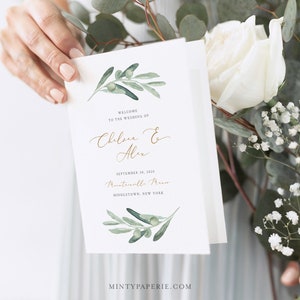 May include: A wedding program with a green olive branch design. The text reads "Welcome to the wedding of Chelsea & Alex, September 30, 2020, Mountainville Manor, Middletown, New York".