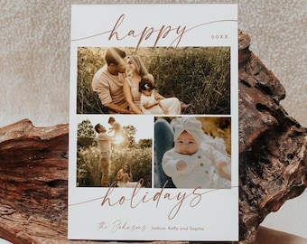 May include: A holiday card with three family photos. The words "happy" and "holidays" are written in a cursive font. The family name is printed at the bottom. The card is displayed on a piece of wood.