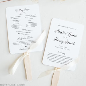 May include: A white wedding ceremony programme fan with black text. The fan features the names Amelia Louise and Henry David, the wedding date, and the location. The back of the fan includes the ceremony order, which includes the processional, readings, and recessional.