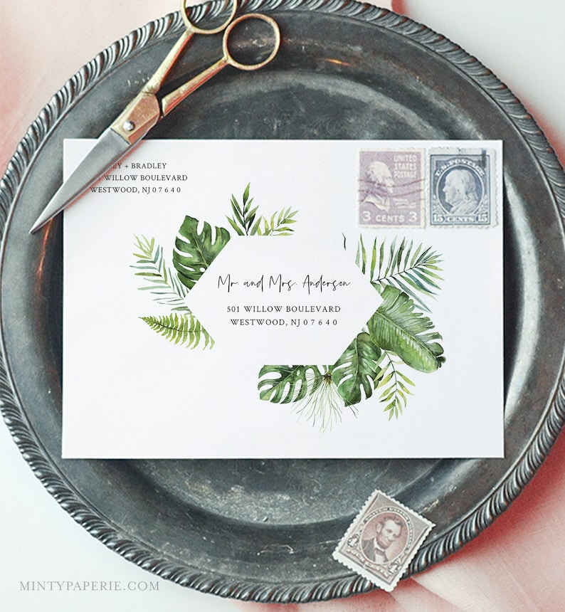 May include: A white envelope with a tropical leaf design and a hexagonal address label. The address label reads "Mr. and Mrs. Anderson, 501 Willow Boulevard, Westwood, NJ 07640".