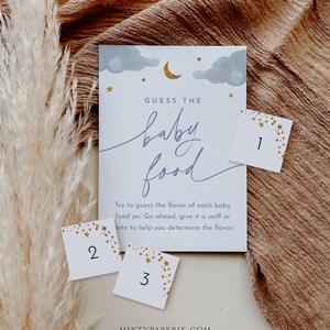 May include: A baby shower game with a blue and white background with gold stars. The game is called "Guess the Baby Food". There are three cards with numbers 1, 2, and 3 on them.