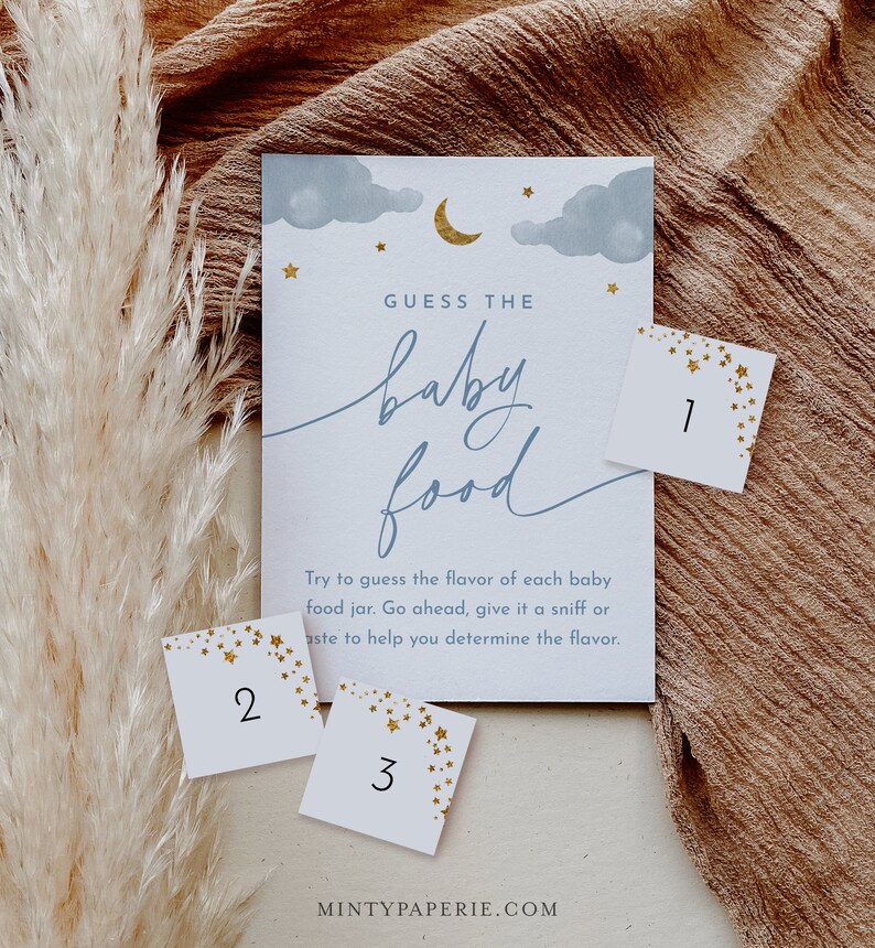 May include: A baby shower game with a blue and white background with gold stars. The game is called "Guess the Baby Food". There are three cards with numbers 1, 2, and 3 on them.