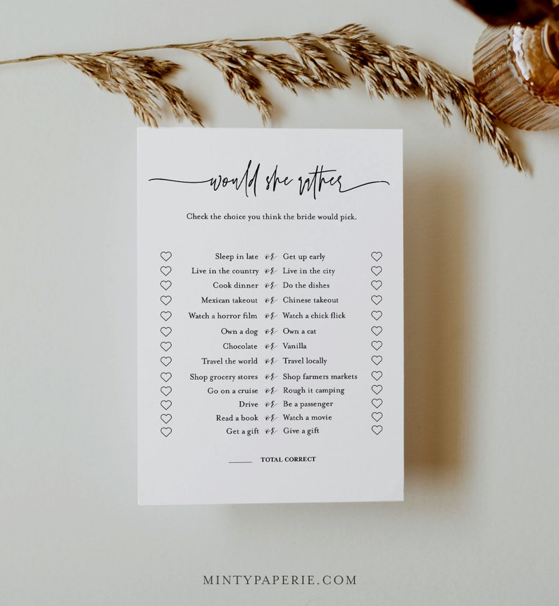 May include: A printable "Would She Rather" bridal shower game with a list of 15 questions for guests to guess the bride's preferences. The game is printed on white cardstock with a black border and a handwritten font.