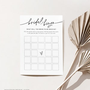 May include: A printable bridal bingo card with the text "bridal bingo" and "What will the bride-to-be receive?" Fill in the squares with your best guesses. Mark the squares that match as she opens her gifts. First person to get 5 in a row wins!"