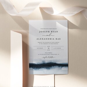 May include: Wedding invitation with a watercolor background in shades of blue. The invitation features the names Joseph Ryan and Alexandria Rae, the date Saturday, June 15, 2020, and the time 12 o'clock. The invitation also includes the location Villa Veneza, 501 Willow Boulevard, Middletown, NY.