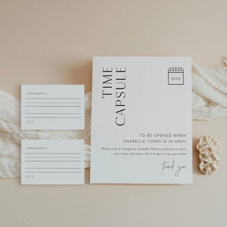 May include: White card with black text that reads "Time Capsule" and "To be opened when Anabelle turns 18 in 20XX!"  The card also includes a calendar icon with the year 20XX.  There are two blank white cards with black text that reads "Dear Anabelle" and a line for writing.
