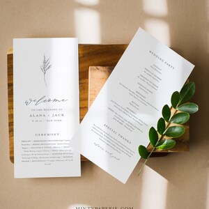 May include: A minimalist wedding ceremony program with a simple floral design. The program includes the wedding party, ceremony details, and a special thanks section. The text reads "Welcome to the wedding of Alana + Jack 6.18.21 New York".