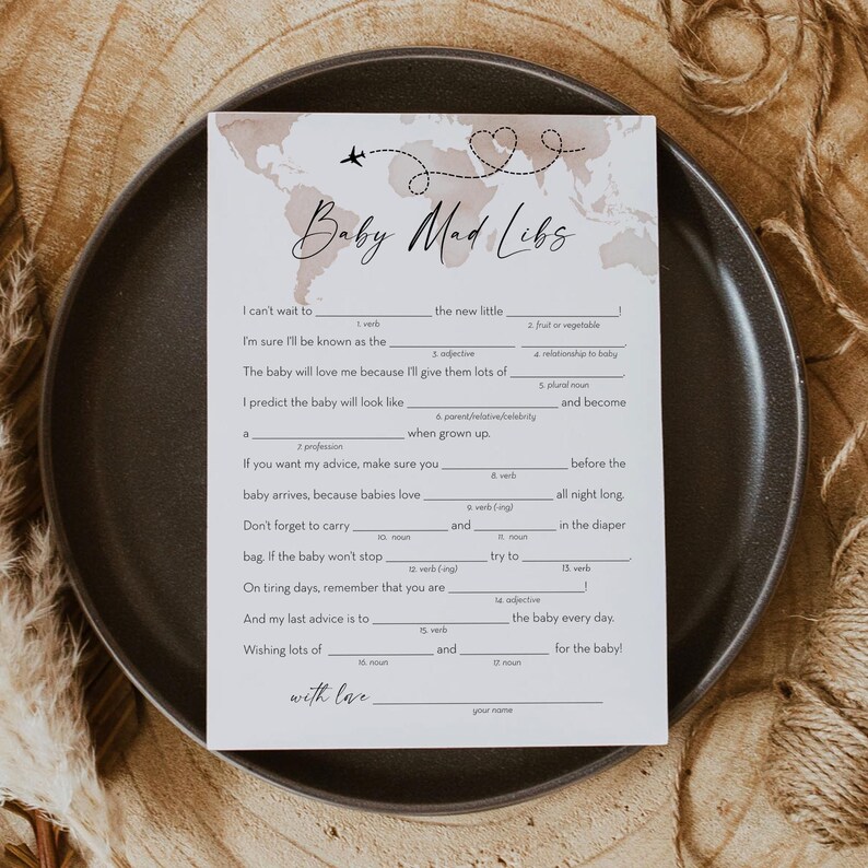 May include: A printable baby shower game card with a watercolor world map background. The card has the title "Baby Mad Libs" and includes fill-in-the-blank sentences about a new baby.