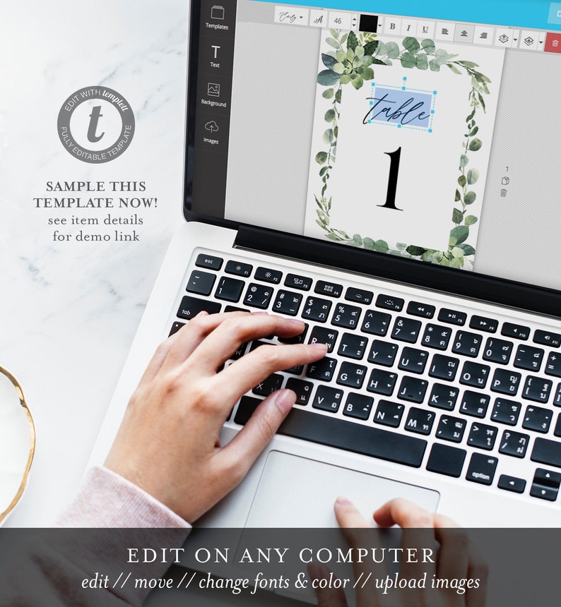 May include: A laptop computer screen displaying a digital template for a table number card. The card features a green watercolor design with the text "table 1".