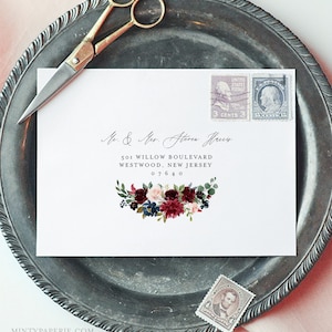 May include: A white envelope with a burgundy floral design and the text "Mr. & Mrs. Steven Haus" and "501 Willow Boulevard, Westwood, New Jersey 07640".