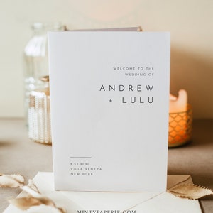 May include: A white wedding invitation card with the text "Welcome to the Wedding of Andrew + Lulu" and the date "9.23.2020" followed by the location "Villa Veneza, New York".