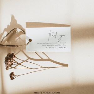 May include: A white thank you tag with brown twine attached. The tag has the text "thank you" in cursive script and the message "We thank you for your continuous love and support and for spending this special day with us. SLOANE + ANDREW".