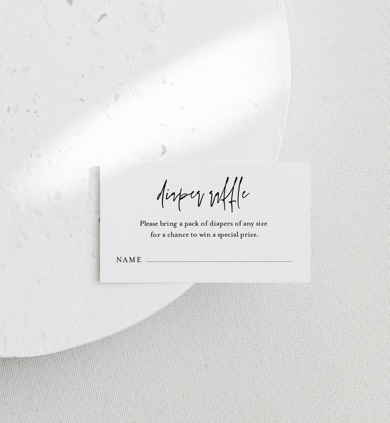 May include: A white card with black text that reads "Diaper Raffle". The text below says "Please bring a pack of diapers of any size for a chance to win a special prize." There is a blank line for a name.