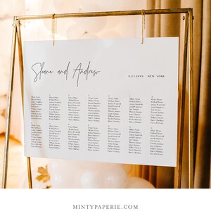 May include: A white wedding seating chart with black text. The chart is titled "Sloane and Andrew" and lists the names of guests under table numbers 1 through 16. The date "9.23.20XX" and location "NEW YORK" are printed at the top right corner of the chart.