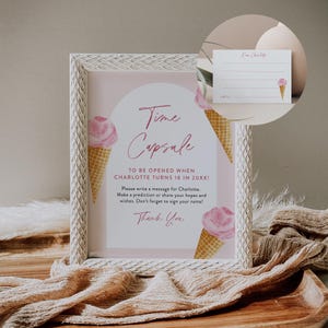 Puede incluir: Un marco blanco con un cartel rosa y blanco que dice "Time Capsule" y "To be opened when Charlotte turns 18 in 20XX!"  El cartel tiene un cono de helado rosa con un cono de waffle a cada lado.  El cartel tambi&eacute;n dice "Please write a message for Charlotte. Make a prediction or share your hopes and wishes. Don't forget to sign your name! Thank you."