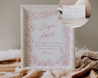 May include: A white frame with a floral design around the border. The sign reads "Diaper Raffle" and says "If you brought a pack of diapers for the raffle, please place your ticket and diapers here. Thank you."