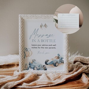 May include: A white frame with a sign that says "Message in a Bottle" with a blue and white race car design. The sign is on a wooden table with a blue and brown fabric.