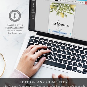 May include: A laptop computer with a white background and a screen displaying a wedding invitation template with a lemon and leaf design. The text on the screen reads "welcome to the wedding of Layla + Ryan 5.18.21 - New York". The laptop keyboard is visible with a hand typing on it.