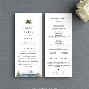 May include: Wedding ceremony program with a watercolor illustration of a mountain range and pine trees. The program includes the names Emily and Mark, the date June 27, 2020, and the location Middletown, New York. The program also includes the order of events for the ceremony, including the prelude, processional, bridal processional, reading, welcome and prayer, solo, marriage rite, vows, exchange of rings, declaration of marriage, wedding prayer, and recessional.