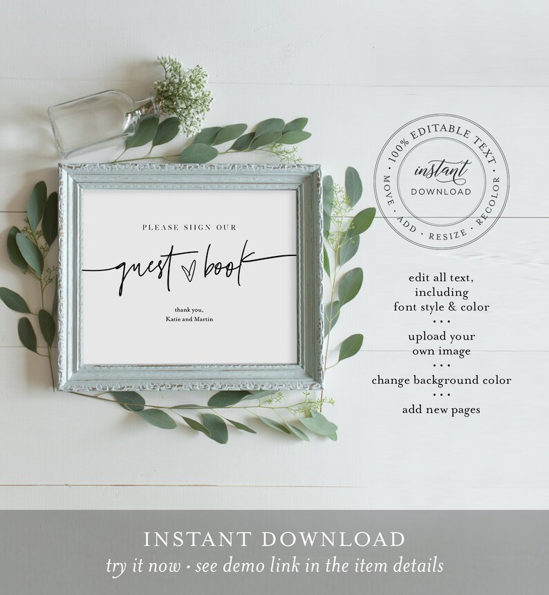 May include: A printable sign in a light blue frame with the text "PLEASE SIGN OUR guest book" and "thank you, Katie and Martin". The sign is on a white wooden surface with green leaves.