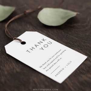 May include: White thank you tag with black text that reads "THANK YOU" and "We thank you for your continuous love and support and for spending this special day with us."  The tag also includes the names "ANDREW + LULU" in black text.