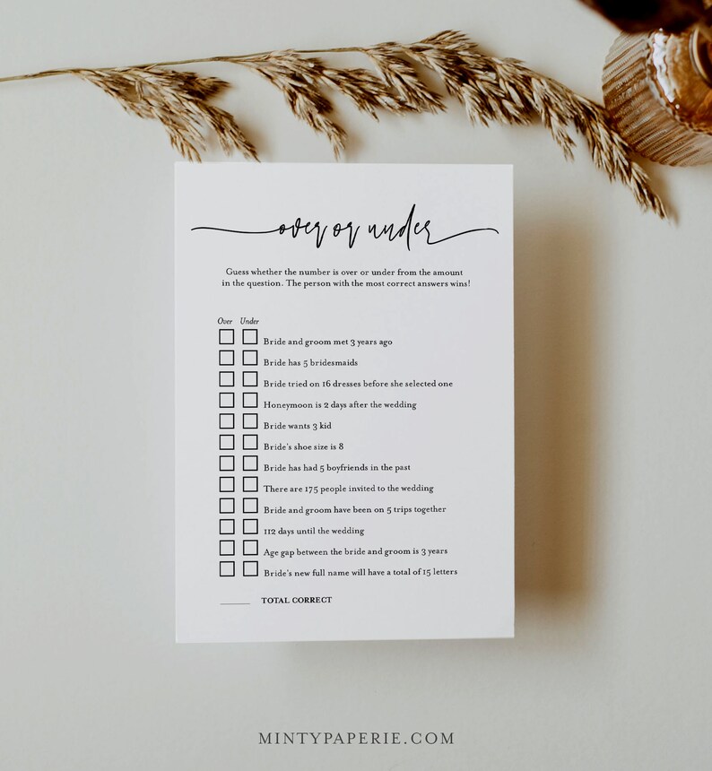 May include: A printable wedding game card with the title "Over or Under" and a list of questions about the bride and groom. Players must guess if the answer is over or under the given number. The card has a black and white design.
