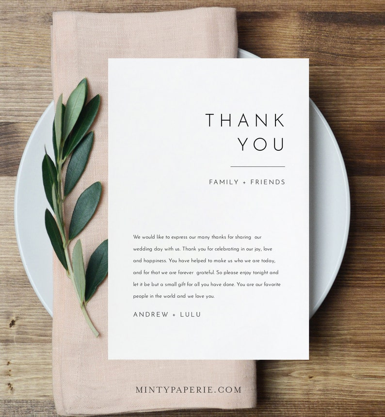 May include: A white thank you card with black text. The text reads "Thank You" in a large font, followed by "Family + Friends" in a smaller font. The card also includes a message expressing gratitude to guests for attending a wedding.