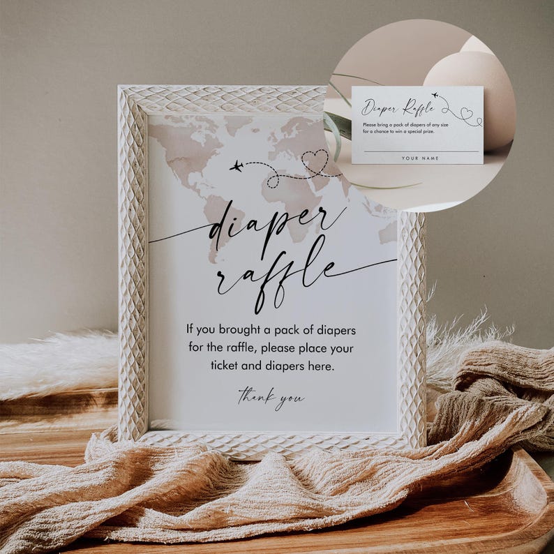 May include: A white frame with a sign that says "diaper raffle". The sign has a world map with a pink and brown watercolor design. The text says "If you brought a pack of diapers for the raffle, please place your ticket and diapers here. Thank you."