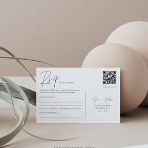 May include: A white RSVP card with a black handwritten RSVP, a QR code, and the text "BY 9.15.20XX". The card also includes a section for guest names, a checkbox for "Joyfully Accepts" and "Regretfully Declines", and a space for dietary requirements. The bottom of the card includes the text "STAMP OR SCAN ME" and the names "Shane & Andrew" with their address and postcode.