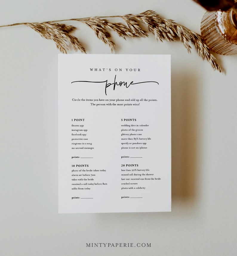 May include: A printable game card with the title "What's on your phone" and a list of items to check for on a phone, with points assigned to each item. The game is designed for a wedding or bridal shower.