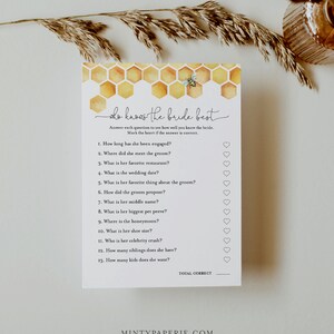 May include: A printable bridal shower game with a honeycomb pattern and a bee illustration. The game is titled "Who Knows the Bride Best?" and asks 13 questions about the bride, with a heart next to each question for guests to mark their answers.