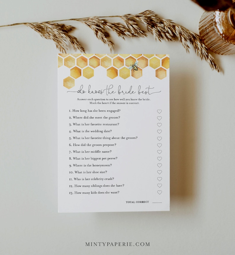May include: A printable bridal shower game with a honeycomb pattern and a bee illustration. The game is titled "Who Knows the Bride Best?" and asks 13 questions about the bride, with a heart next to each question for guests to mark their answers.