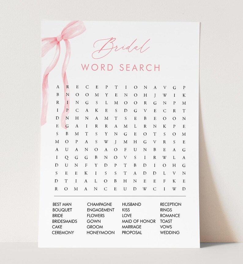 May include: A white bridal word search puzzle with a pink ribbon and the word "Bridal" in elegant script. The puzzle includes words like "Bride," "Groom," and "Wedding." A fun activity for a bridal shower.