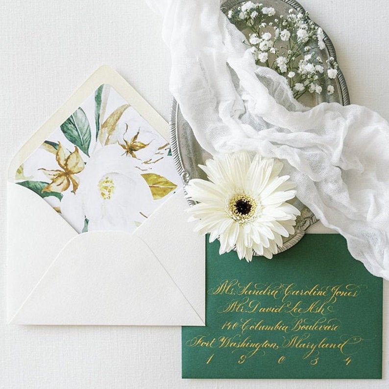 May include: A white envelope with a floral design on the front. The envelope is addressed to Ms. Sandra Caroline Jones and Mr. David Le Ash at 140 Columbia Boulevard, Fort Washington, Maryland 19034.