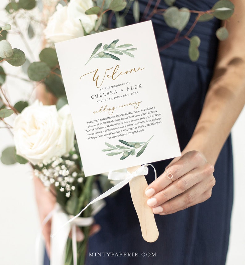 May include: A white wedding ceremony program fan with a green olive branch design. The text reads "Welcome to the wedding of Chelsea + Alex August 14, 2010 New York Wedding Ceremony".