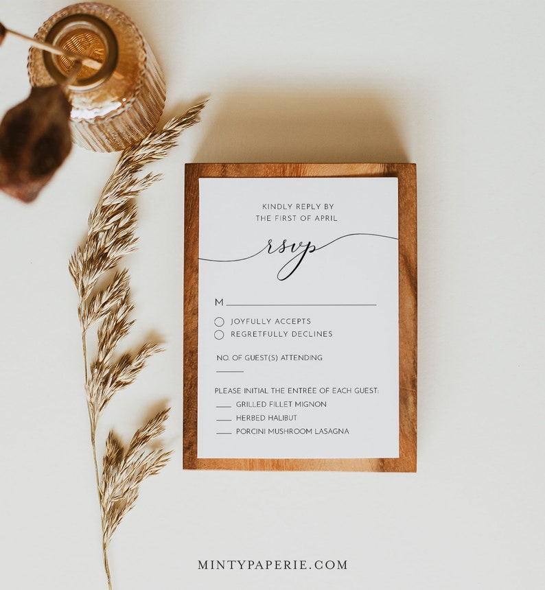 May include: A wooden framed RSVP card with a handwritten RSVP in cursive. The card has a checklist for guests to indicate their attendance and a list of entree options.