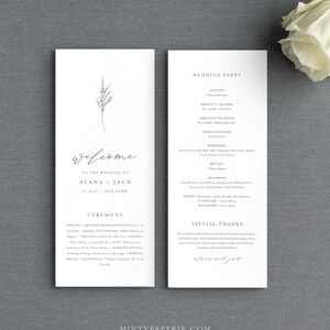 May include: A wedding ceremony program with a simple design featuring a single sprig of grass. The program includes the names of the wedding party, the officiant, and the order of the ceremony. The text "Welcome to the wedding of Alana + Jack 6.18.21 New York" is printed at the top of the program.