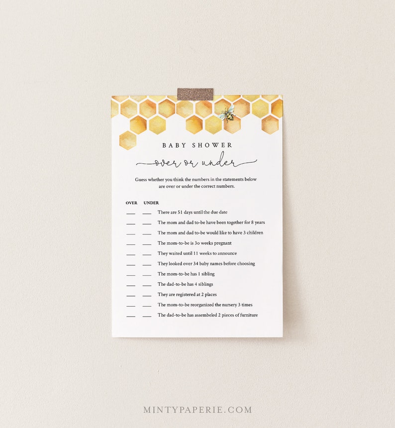 May include: A printable baby shower game card with a honeycomb pattern and a bee illustration. The game is called "Over or Under" and asks guests to guess whether the numbers in the statements are over or under the correct numbers.